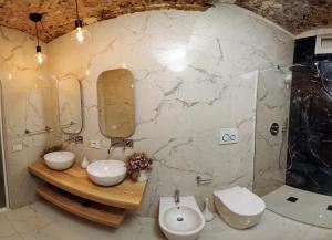 a bathroom with two sinks and two mirrors at extra luxury apartment salerno center in Salerno +69 photos