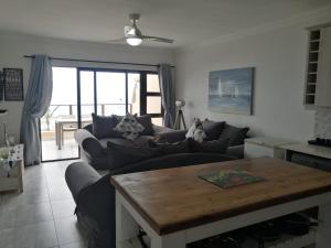 a living room with a couch and a table at Summer Place 36 in Margate