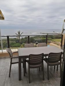 a table and chairs on a balcony with a view of the ocean at Summer Place 36 in Margate