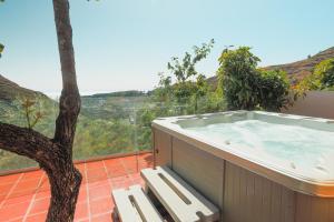 einen Whirlpool auf einem Balkon mit einem Baum in der Unterkunft El Estanco 14 in Vega de San Mateo