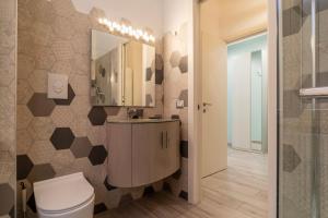 a bathroom with a toilet and a sink and a mirror at Casa Mariu' a San Pietro in Rome +31 photos