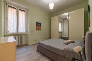 a bedroom with a bed and a large mirror at Casa Mariu' a San Pietro in Rome