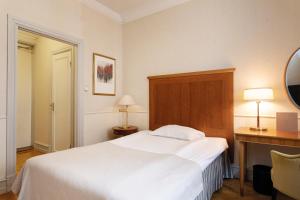 Postel nebo postele na pokoji v ubytování Elite Hotel Savoy