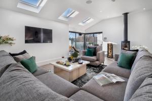 a living room with a couch and a table at Berkeley House in Windermere