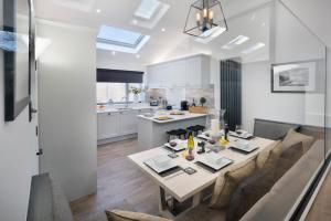 a kitchen and dining room with a table and chairs at Berkeley House in Windermere