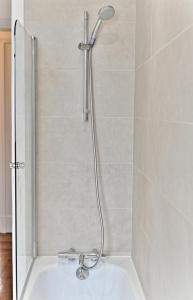a shower in a bathroom with a bath tub at Luxurious Flat next Paris - Neuilly - II in Neuilly-sur-Seine