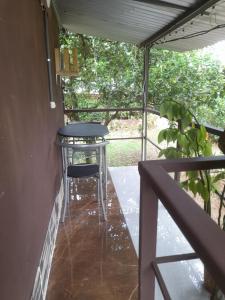 a table and stool sitting on a porch at Chava Camping Rio Celeste in Rio Celeste