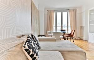 a living room with two beds and a table at Luxurious Flat next Paris - Neuilly - II in Neuilly-sur-Seine