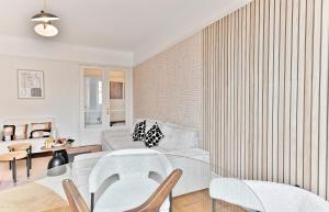 a living room with a glass table and chairs at Luxurious Flat next Paris - Neuilly - II in Neuilly-sur-Seine +44 photos