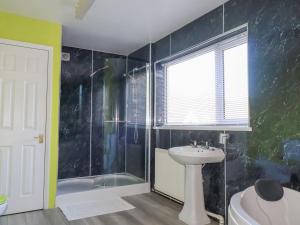 a bathroom with a shower and a sink and a tub at Eden Retreat in Par +24 photos