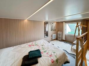 a bedroom with a large bed and a staircase at Tiny House moderne à Disneyland in Coutevroult