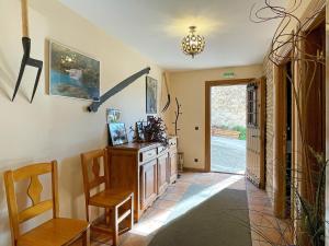 a hallway with a table and chairs in a house at Casar Rural Lazkua I-II in Eraul