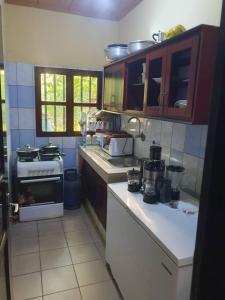 a kitchen with a stove and a counter top at Village des Aviateurs 