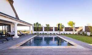 a swimming pool in the backyard of a house at St Francis Golf Lodge in St Francis Bay