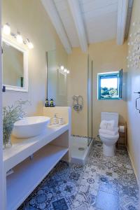 a bathroom with a sink and a toilet at Rhodian Gaea Villa in Theologos