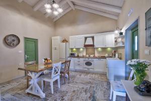 a kitchen with a wooden table and a dining room at Rhodian Gaea Villa in Theologos