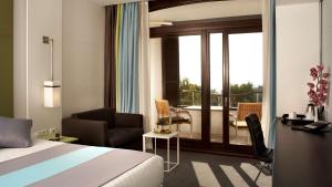 a hotel room with a bed and a balcony at Park Plaza Histria Pula in Pula