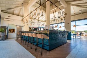 a lobby with a bar with chairs and tables at Park Plaza Histria Pula in Pula