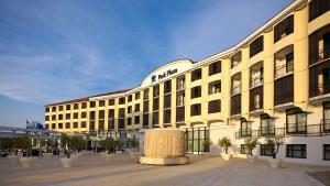a large yellow building with a sign on it at Park Plaza Histria Pula in Pula