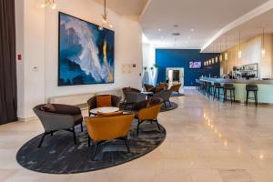 a waiting room with chairs and a bar at Park Plaza Histria Pula in Pula