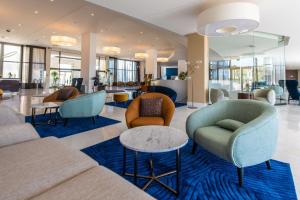 a lobby with couches and chairs and tables at Park Plaza Histria Pula in Pula