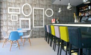 a restaurant with a bar with chairs and a table at Park Plaza Histria Pula in Pula