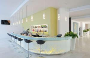 a lobby with a bar with stools around it at Park Plaza Histria Pula in Pula