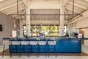 a bar with blue counter tops and bar stools at Park Plaza Histria Pula in Pula