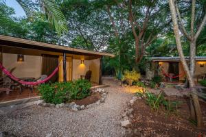 a house with a hammock in front of it at Casa Tropical Playa Grande in Cuajiniquil