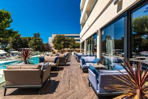 a row of lounge chairs in front of a building at Park Plaza Arena Pula in Pula