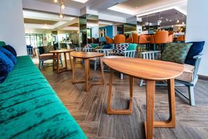 a group of tables and chairs in a restaurant at Park Plaza Arena Pula in Pula