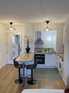 a kitchen with a table and two chairs at Very nice and quiet 42 m in Suresnes with parking in Suresnes