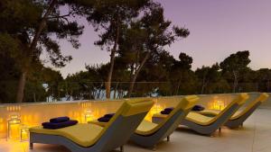 a group of chairs sitting next to a swimming pool at Park Plaza Arena Pula in Pula