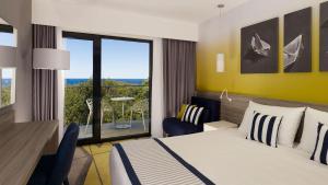 a hotel room with a bed and a balcony at Park Plaza Arena Pula in Pula