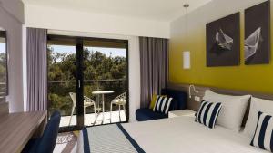 a hotel room with a bed and a balcony at Park Plaza Arena Pula in Pula