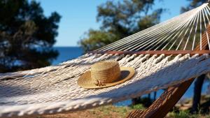 a straw hat is sitting on a hammock at Park Plaza Arena Pula in Pula