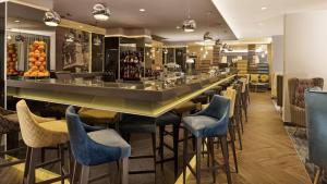 a bar in a restaurant with blue stools at Park Plaza Arena Pula in Pula