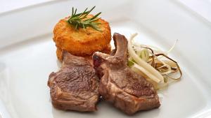 a plate of food with meat and vegetables on it at Park Plaza Arena Pula in Pula