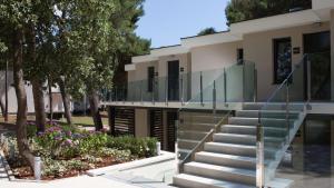 a house with a glass staircase in front of it at Park Plaza Arena Pula in Pula