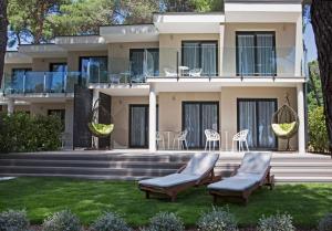 a house with chairs in front of it at Park Plaza Arena Pula in Pula