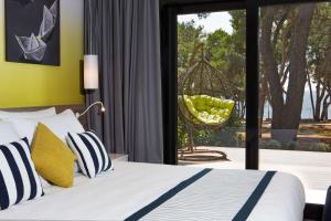 a bedroom with a bed and a swing at Park Plaza Arena Pula in Pula