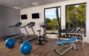 a gym with exercise equipment and a large window at Park Plaza Arena Pula in Pula