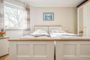 a bedroom with two beds and a desk with two beds at Friedenstraße 7 Whg 4 in Zingst