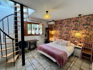 a bedroom with a bed in a room with a staircase at Hotel Altea Paradise 1917 - Adults Only in Altea