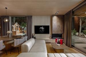a living room with a white couch and a table at Villa Luiv Chalet in Mrkopalj
