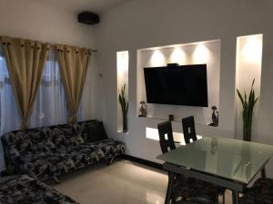 a living room with a glass table and a couch at Casa_22_Melgar in Melgar