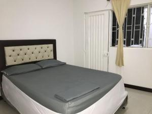 a large bed in a room with a window at Casa_22_Melgar in Melgar +13 photos