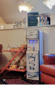 a room with a refrigerator and a shelf with dishes at Bed & Breakfast Morelli 49 in Naples