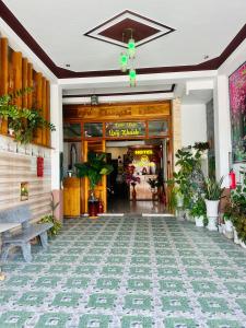 a lobby of a restaurant with a bench in front of it at Ngọc Nga Hotel in Phan Rang–Tháp Chàm