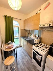 a small kitchen with a table and a stove at Cozy Studio in Angel (Islington) in London